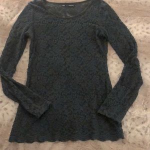 Lacy top. Deep/rich green. Scalloped details at bottom. Black trim at neck.